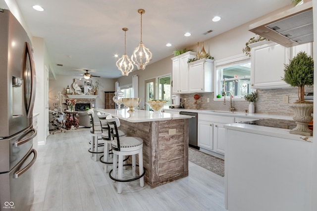 6054 Easy Ln, Indianapolis, IN 46259 - kitchen featuring appliances with stainless steel finishes, a sink, ventilation hood, a ceiling fan, and open floor plan