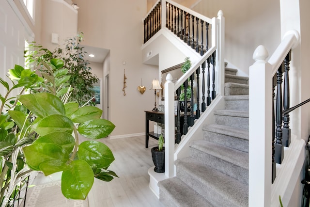 6054 Easy Ln, Indianapolis, IN 46259 - stairway featuring wood finished floors, a towering ceiling, and baseboards