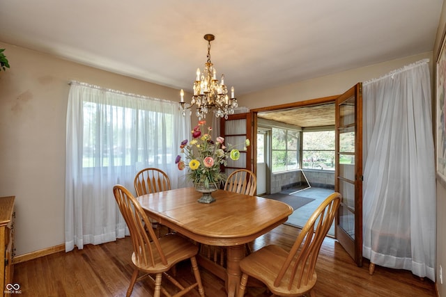 614 Debra Ln, Indianapolis, IN 46217 - dining area featuring baseboards, wood finished floors, and an inviting chandelier