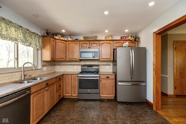 614 Debra Ln, Indianapolis, IN 46217 - kitchen featuring stainless steel appliances, a sink, tasteful backsplash, recessed lighting, and light stone countertops