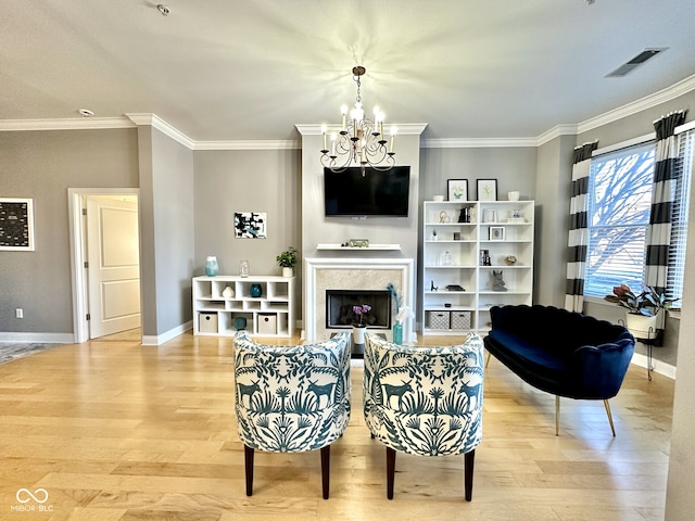living area with a chandelier, visible vents, light wood-type flooring, and baseboards