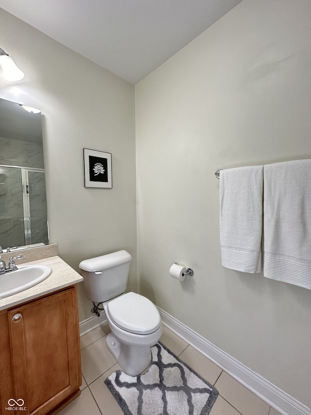 bathroom with baseboards, a stall shower, tile patterned floors, and toilet