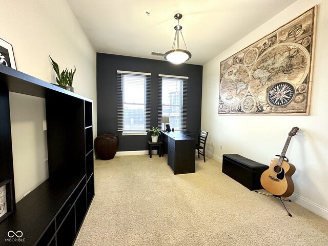office featuring visible vents, light colored carpet, and baseboards