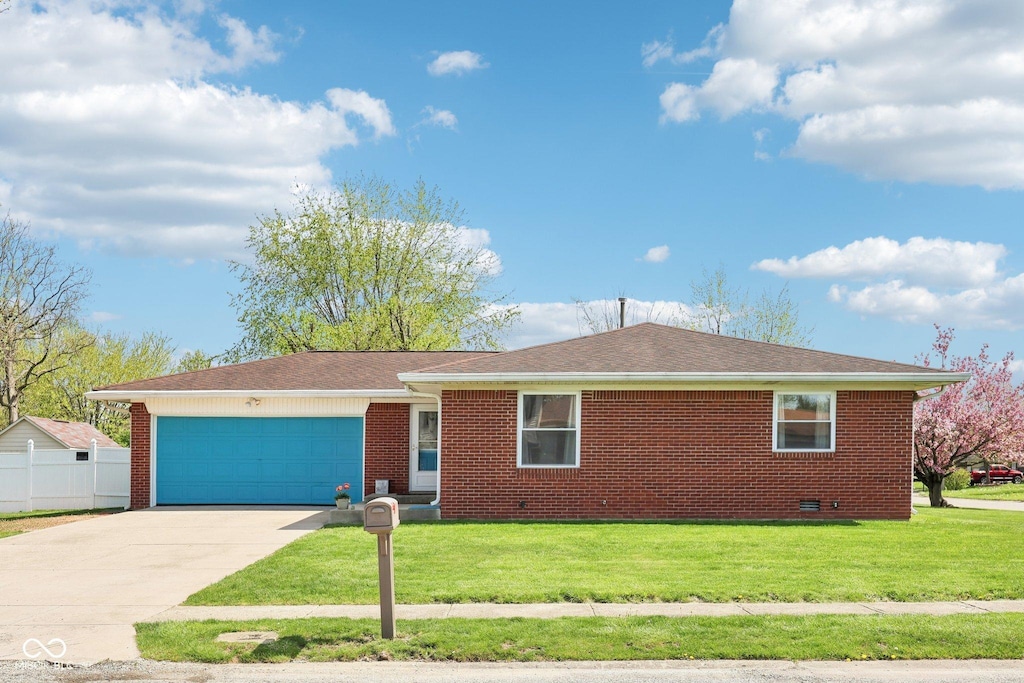 single story home with an attached garage, brick siding, driveway, and a front yard