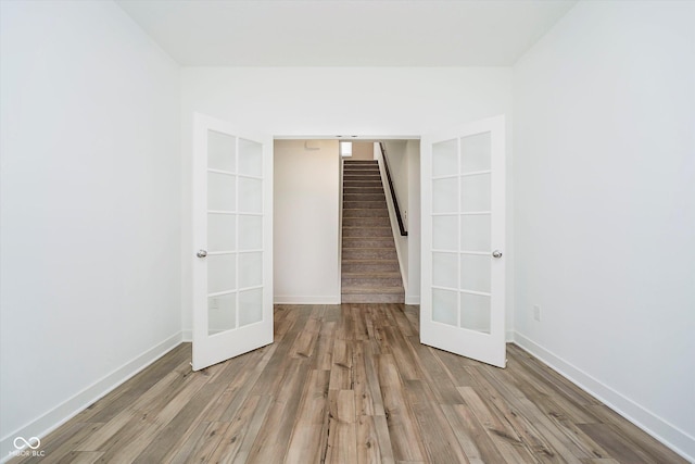 8654 Tripp Rd, Pendleton, IN 46064 - spare room with french doors, wood finished floors, stairway, and baseboards