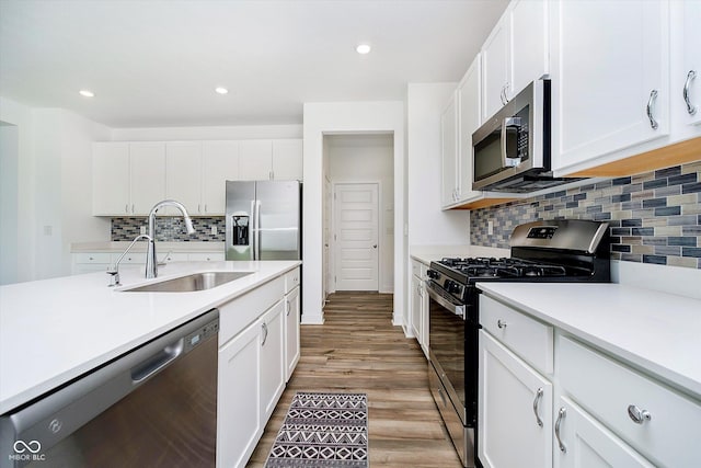 8654 Tripp Rd, Pendleton, IN 46064 - kitchen with stainless steel appliances, a sink, light countertops, decorative backsplash, and recessed lighting