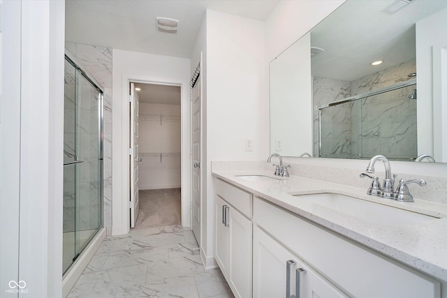 8654 Tripp Rd, Pendleton, IN 46064 - bathroom with marble finish flooring, a marble finish shower, a walk in closet, double vanity, and recessed lighting