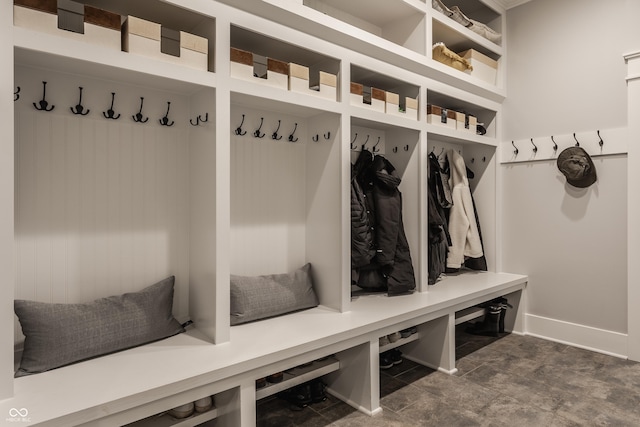 mudroom with baseboards and stone finish floor