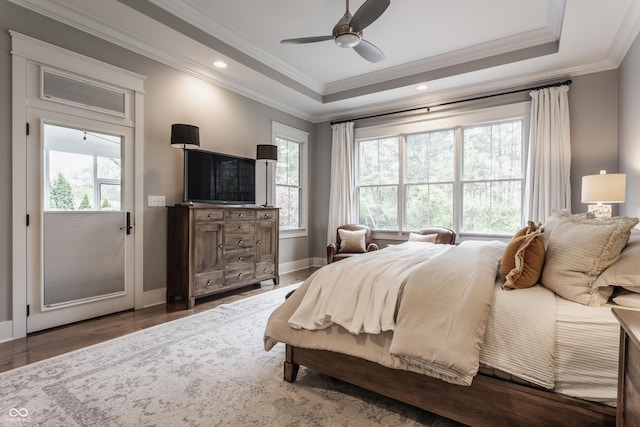 bedroom with baseboards, crown molding, and multiple windows