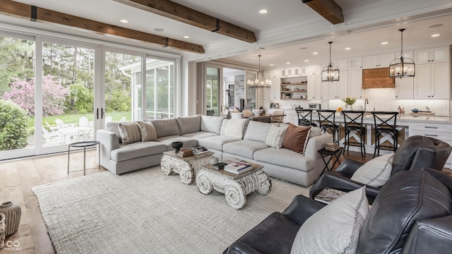 living area with a chandelier, recessed lighting, and beam ceiling