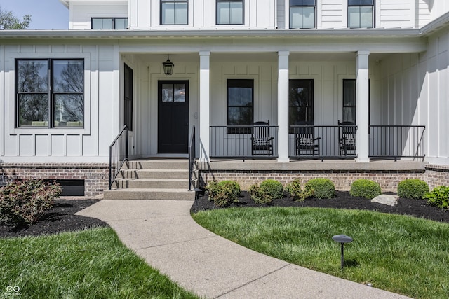 entrance to property featuring board and batten siding and a porch