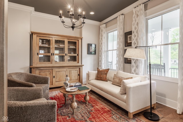 sitting room featuring recessed lighting, an inviting chandelier, crown molding, baseboards, and wood finished floors