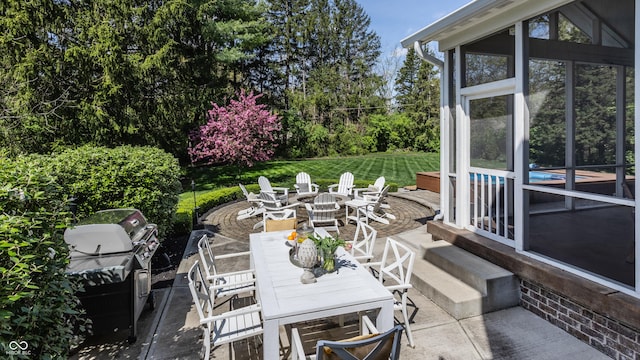 view of patio featuring outdoor dining space, an outdoor pool, a sunroom, and a grill