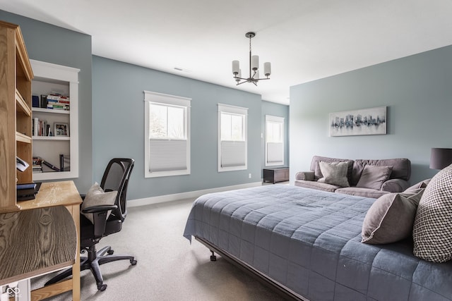 carpeted bedroom with baseboards, visible vents, and a notable chandelier