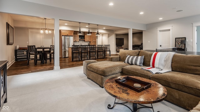 living room featuring wood finished floors, recessed lighting, a chandelier, and carpet floors