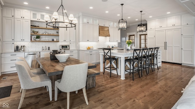 dining room with recessed lighting, an inviting chandelier, and dark wood-style flooring