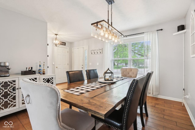 dining room with hardwood / wood-style floors, baseboards, and a chandelier
