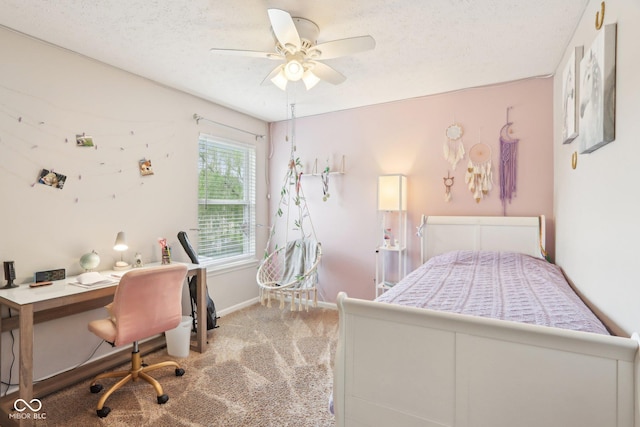 carpeted bedroom featuring baseboards, ceiling fan, a textured ceiling, and an office area