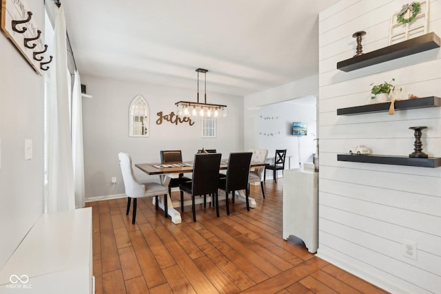 dining room featuring wood finished floors and a chandelier