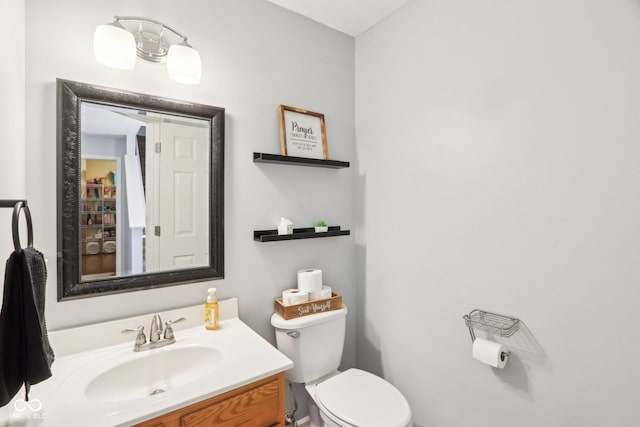 half bathroom featuring toilet and vanity
