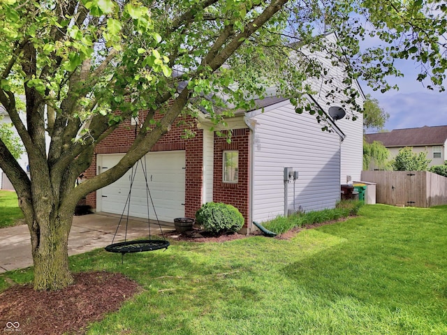 view of home's exterior featuring brick siding, driveway, and a garage