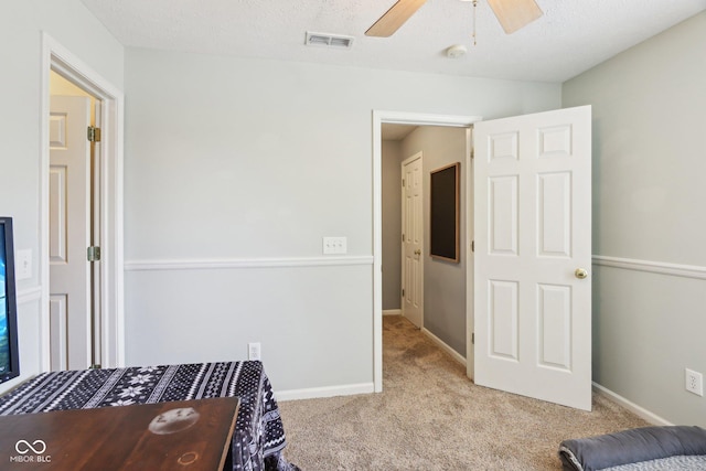 carpeted bedroom featuring a ceiling fan and baseboards