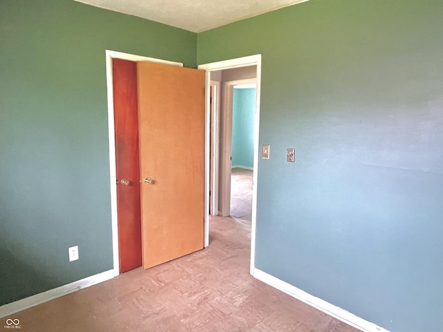 spare room featuring baseboards