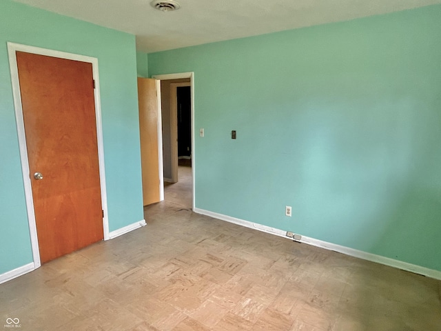 unfurnished bedroom featuring visible vents and baseboards