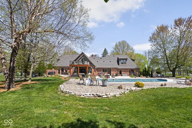 8551 E 300 S, Zionsville, IN 46077 - rear view of house featuring a lawn, an outdoor pool, a chimney, and a patio area
