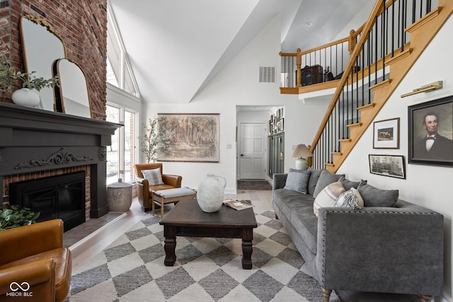 8551 E 300 S, Zionsville, IN 46077 - living room with wood finished floors, stairs, a fireplace, visible vents, and high vaulted ceiling