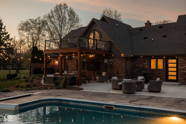 8551 E 300 S, Zionsville, IN 46077 - rear view of property with an outdoor pool, a patio area, a balcony, and brick siding