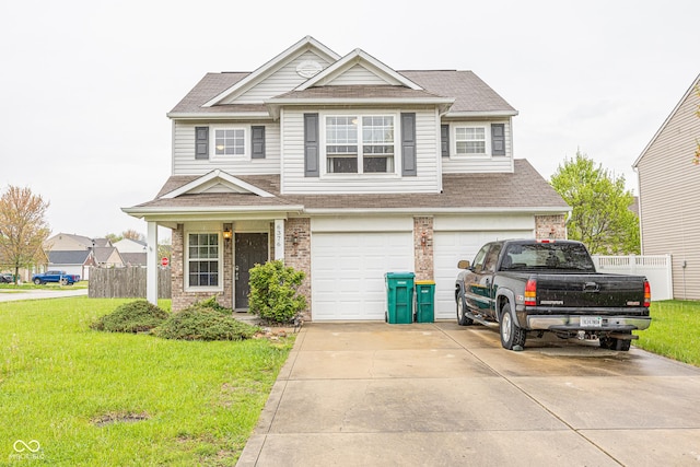 craftsman house with driveway, a shingled roof, a front yard, an attached garage, and fence