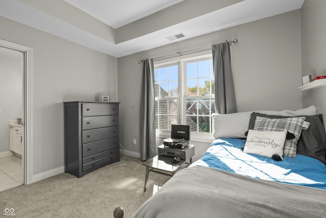 bedroom featuring carpet floors, visible vents, and baseboards