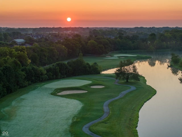view of home's community featuring a water view, golf course view, and a wooded view