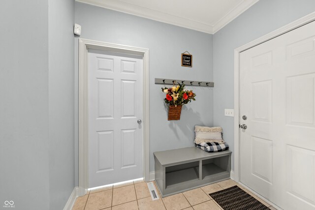 mudroom featuring light tile patterned floors, baseboards, and ornamental molding