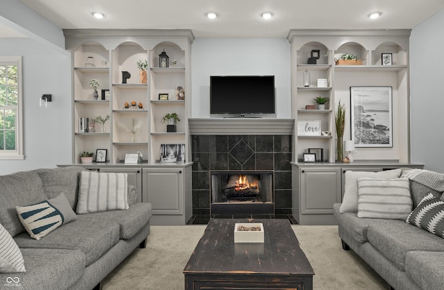 living area with a tile fireplace