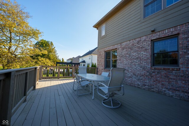 wooden terrace with outdoor dining space
