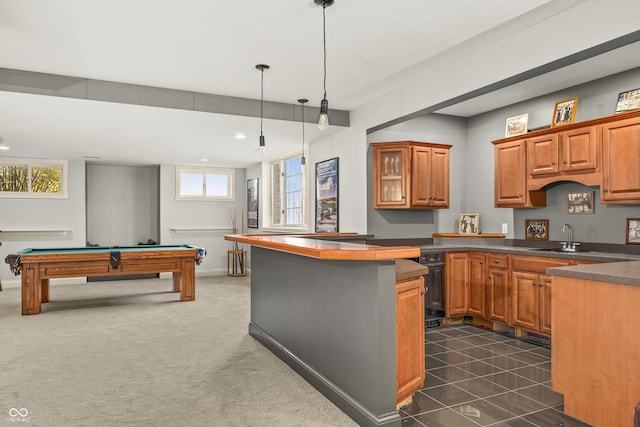 kitchen featuring brown cabinetry, dark countertops, billiards, and a sink