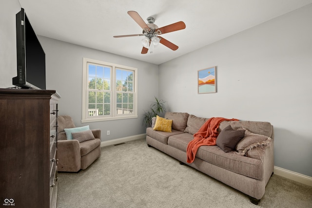 carpeted living area featuring visible vents, baseboards, and ceiling fan