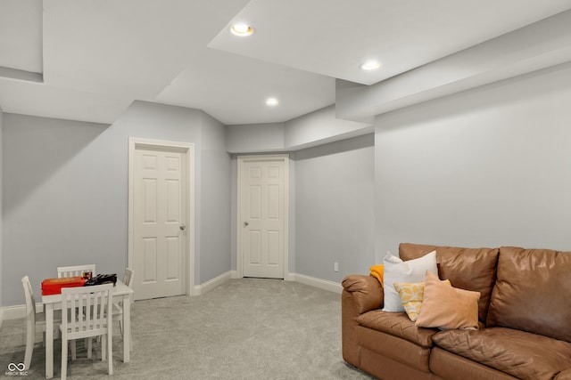 living area featuring recessed lighting, baseboards, and light colored carpet