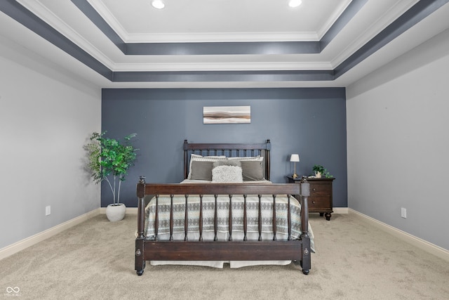 bedroom with baseboards, a tray ceiling, carpet floors, and crown molding