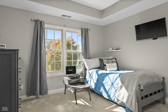 carpeted bedroom featuring baseboards and visible vents