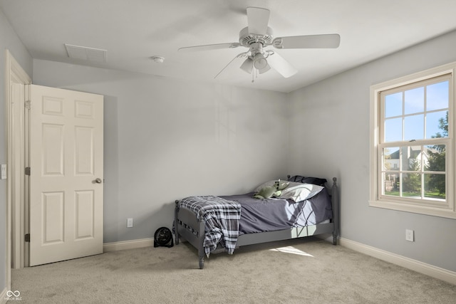 bedroom with multiple windows, visible vents, and carpet