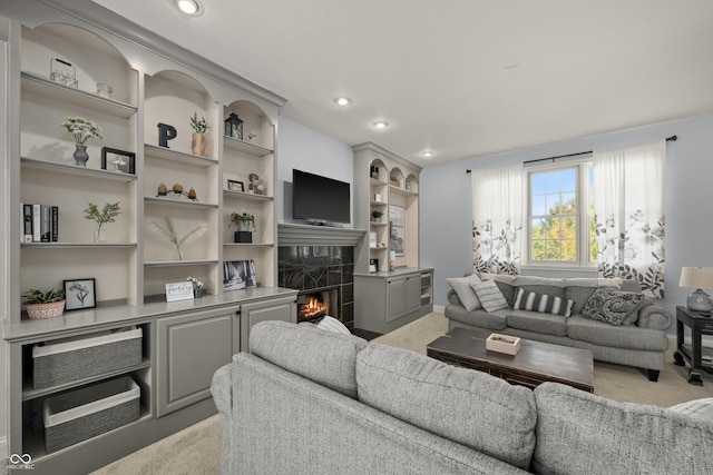 living room with a tile fireplace and recessed lighting
