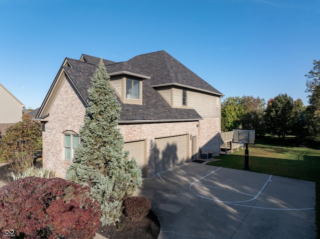 view of home's exterior with a lawn, brick siding, concrete driveway, and a shingled roof