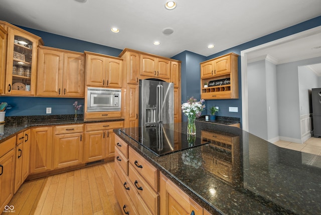 kitchen featuring dark stone counters, open shelves, glass insert cabinets, appliances with stainless steel finishes, and recessed lighting