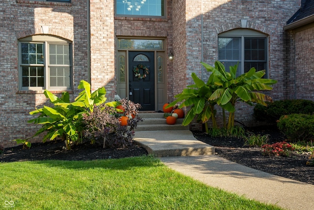 doorway to property with brick siding