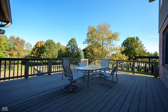wooden terrace with outdoor dining space