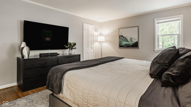 654 E 79th St, Indianapolis, IN 46240 - bedroom featuring wood finished floors, crown molding, and baseboards