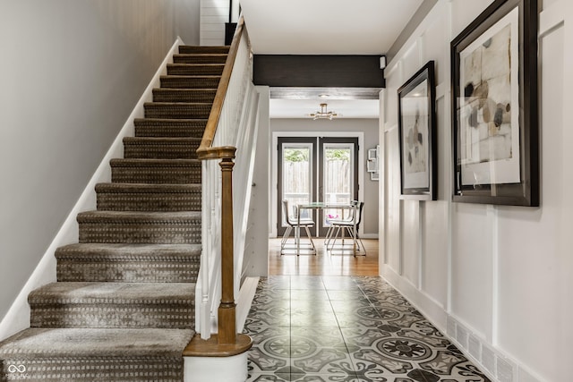 654 E 79th St, Indianapolis, IN 46240 - staircase featuring a chandelier and tile patterned flooring
